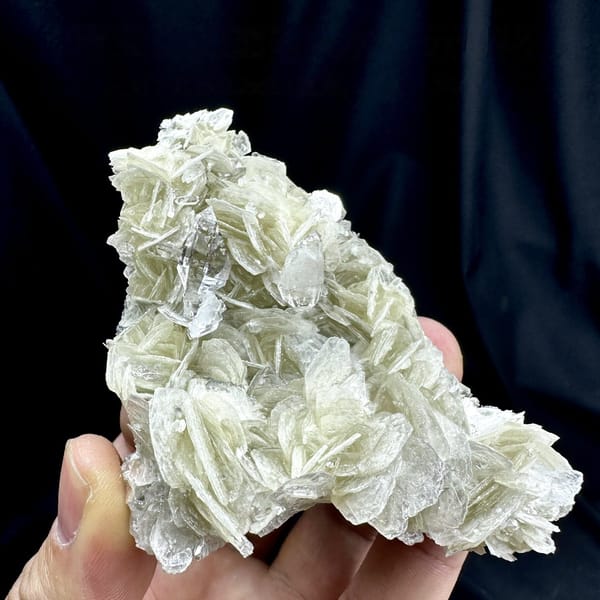 Ultra-clear quartz points among pearly muscovite from Xuebaoding, Sichuan, China, detail of the matrix contact