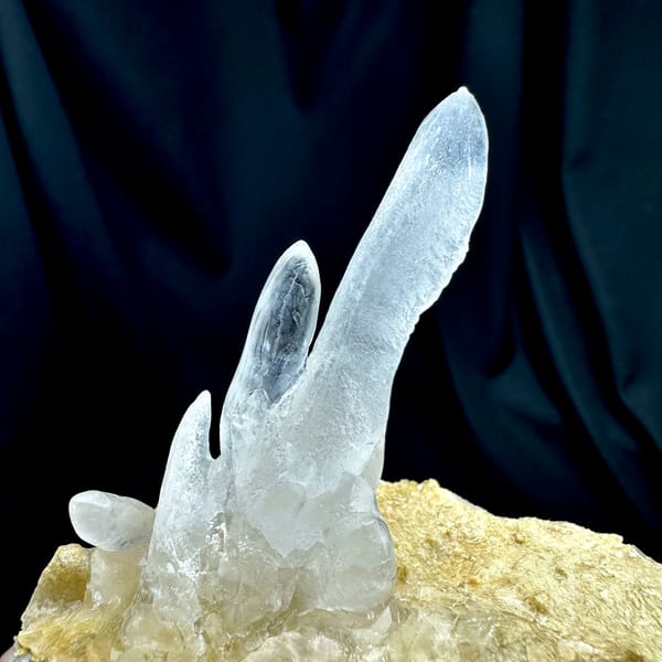 Transparent icicle calcite stalactites on tan base from Yunnan, China, second angle