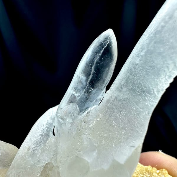 Transparent icicle calcite stalactites on tan base from Yunnan, China, reverse side