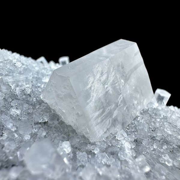 Transparent calcite prism on grey quartz druse from Fujian, China, reverse side