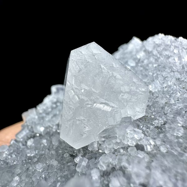 Transparent calcite prism on grey quartz druse from Fujian, China, top view