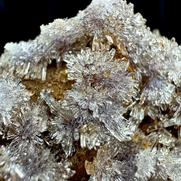 Lavender creedite flowers on ochre matrix from Guizhou, China, top view