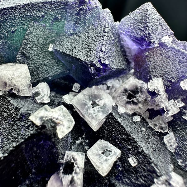 Plate of blue-violet fluorite octahedra with white fluorite cubes from Zhejiang, China, reverse side