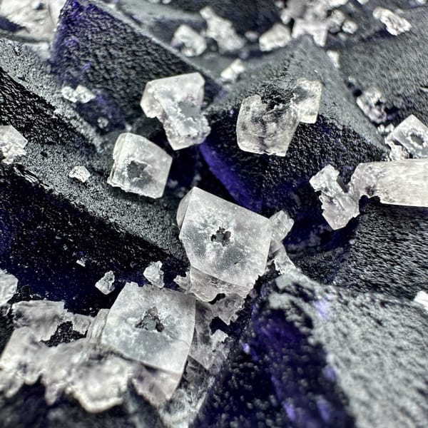 Plate of blue-violet fluorite octahedra with white fluorite cubes from Zhejiang, China, top view