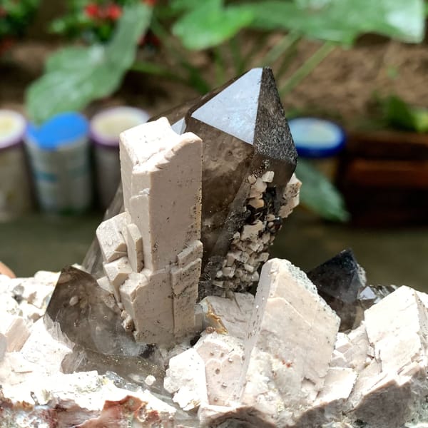 Tall smoky quartz crystal in white feldspar from Fujian, China, second angle