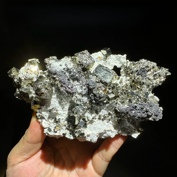 Plate of cubic pyrite with black marmatite and quartz from Shangbao Mine, Hunan, China, held in hand
