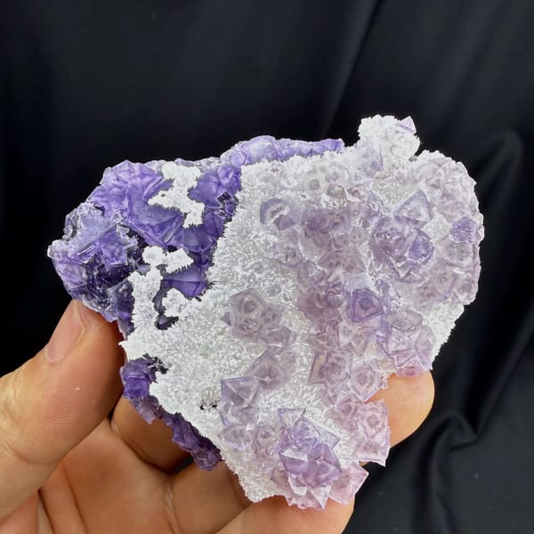 Green-core octahedral purple fluorite on quartz — alternate view