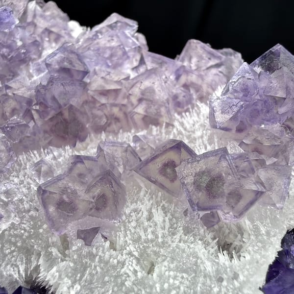 Green-core octahedral purple fluorite on quartz — alternate view