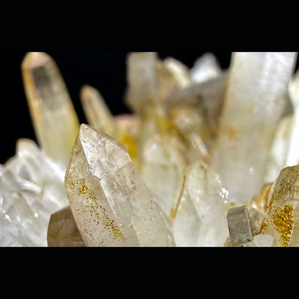 Hexagonal platy calcite on golden quartz cluster — detail view