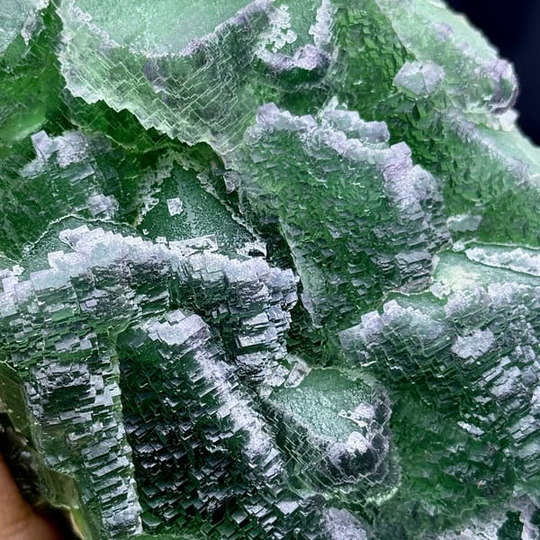 Slab of deep emerald-green stepped fluorite from Zhejiang, China, close-up of the crystal faces