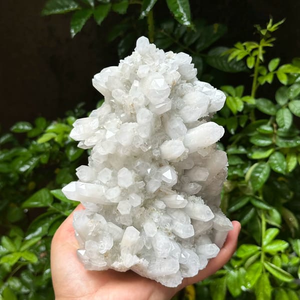 Large white quartz cluster with platy hexagonal calcite from Fujian, China, held in hand