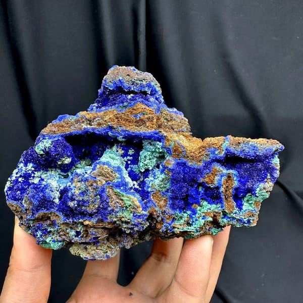Deep blue azurite block laced with green malachite from DR Congo, held in hand