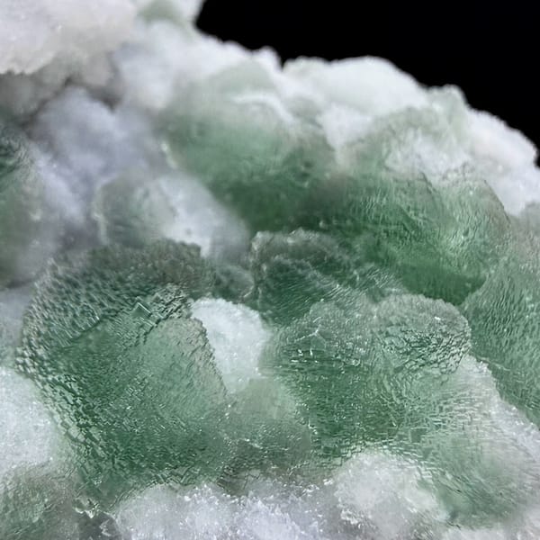 Lavender-grey stepped octahedral fluorite with green corners from Fujian, China, close-up of the crystal faces
