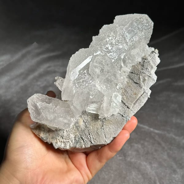 White baryte column with glassy tabular blades from Sichuan, China, held in hand