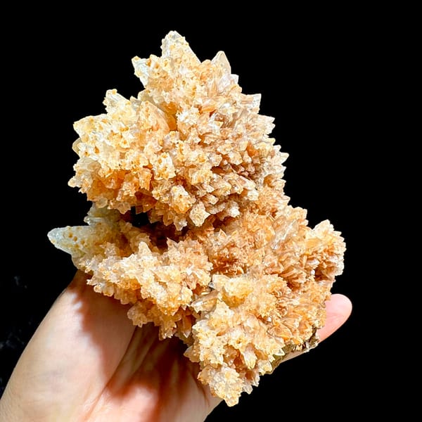 Large peach calcite cluster with sparkling crystal skins from Yunnan, China, close-up of the crystal faces
