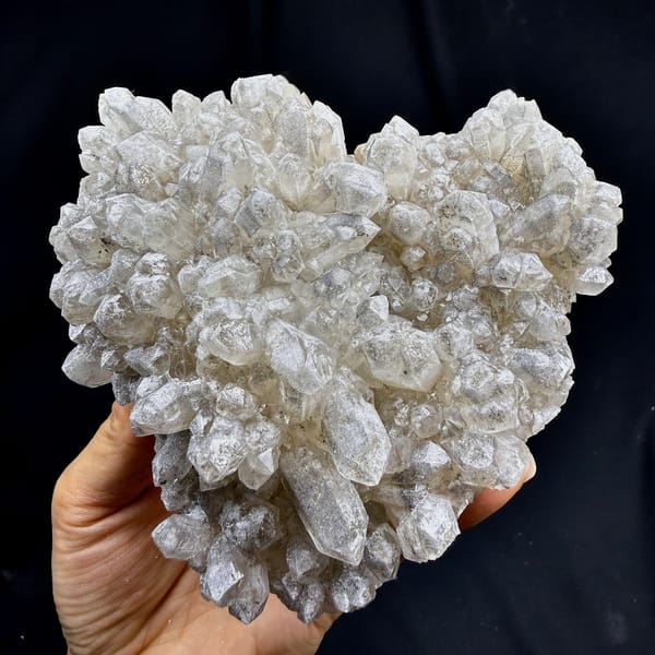 Heart-shaped cluster of pale quartz points from Inner Mongolia, China, detail of the matrix contact