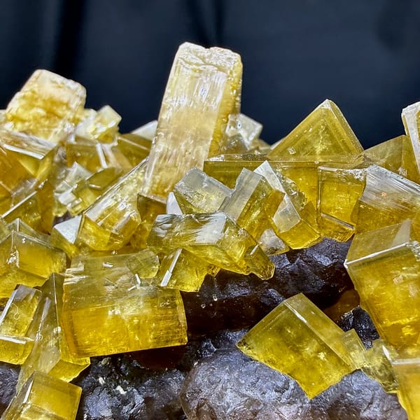 Block of golden baryte blades with purple fluorite from Jiangxi, China, close-up of the crystal faces