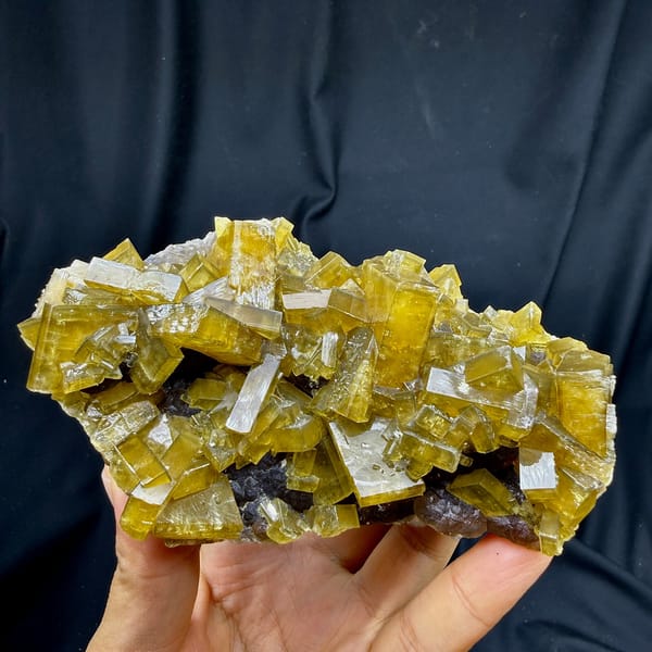 Block of golden baryte blades with purple fluorite from Jiangxi, China, detail of the matrix contact