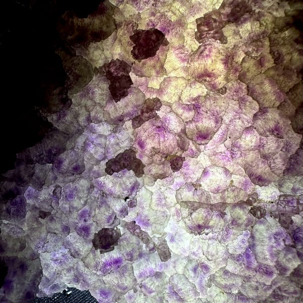 Translucent purple and green fluorite slab from Fujian, China, close-up of the crystal faces