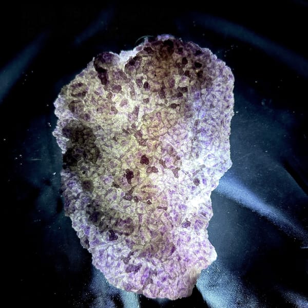Translucent purple and green fluorite slab from Fujian, China, detail of the matrix contact