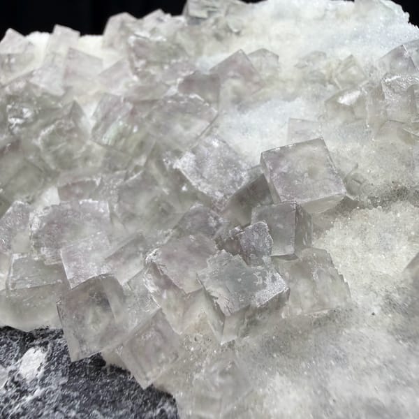 Plate of pale pink-green fluorite cubes on dark quartz from Henan, China, reverse side