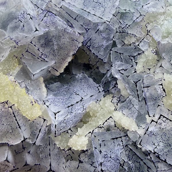 Purple-edged QR-code fluorite cubes with quartz from Guizhou, China, close-up of the crystal faces