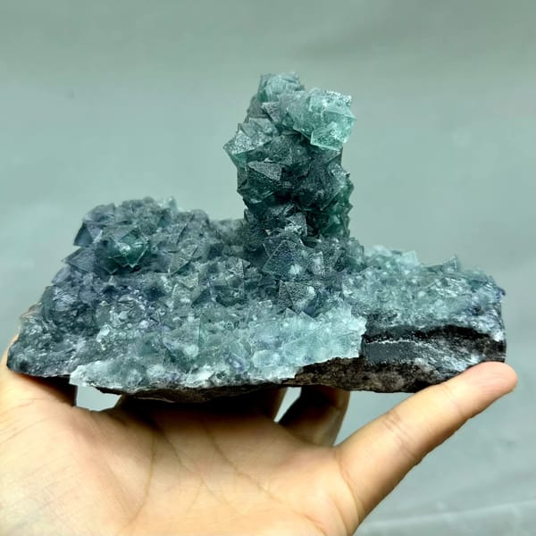 Teal-green octahedral fluorite tower on dark quartz plate from Inner Mongolia, China