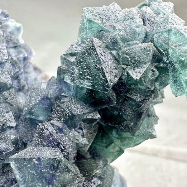 Teal-green octahedral fluorite tower on dark quartz plate from Inner Mongolia, China, top view