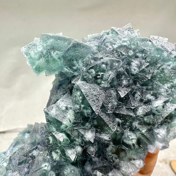 Teal-green octahedral fluorite tower on dark quartz plate from Inner Mongolia, China, another angle