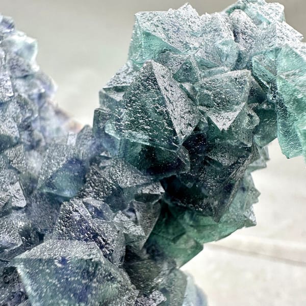 Teal-green octahedral fluorite tower on dark quartz plate from Inner Mongolia, China, detail of the associations