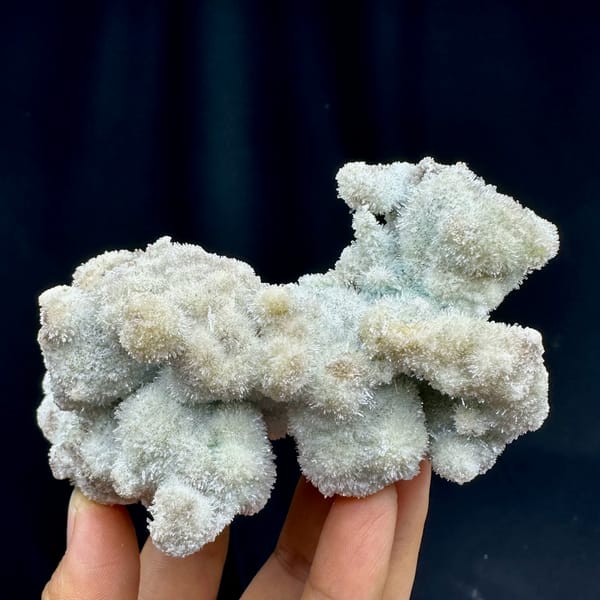 Fuzzy blue-green creedite balls in branching cluster from Guizhou, China, close-up of the crystal faces