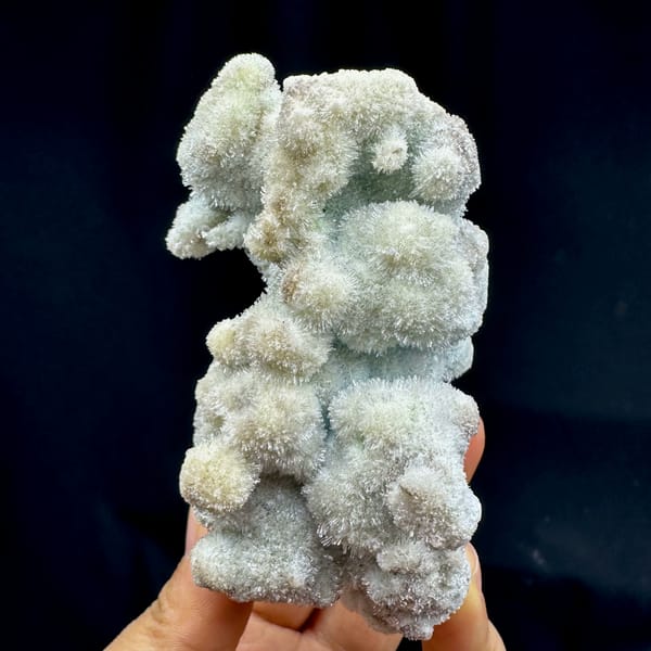 Fuzzy blue-green creedite balls in branching cluster from Guizhou, China, reverse side