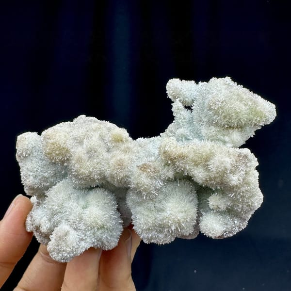 Fuzzy blue-green creedite balls in branching cluster from Guizhou, China, detail of the matrix contact