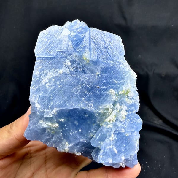 Block of pale blue calcite with peridot grains from Vietnam, second angle
