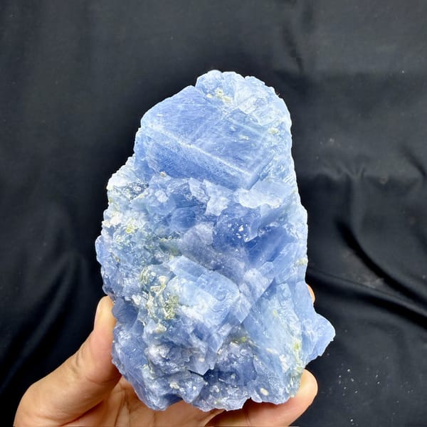 Block of pale blue calcite with peridot grains from Vietnam, detail of the matrix contact