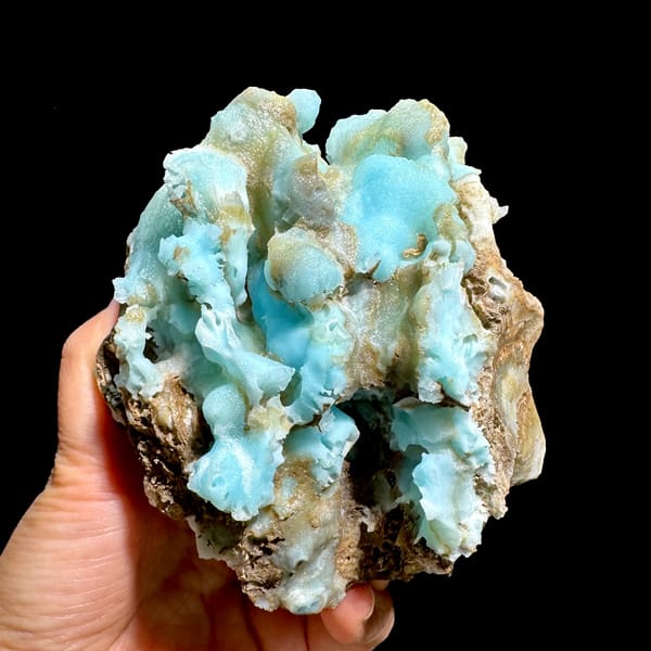 Robin's-egg blue botryoidal aragonite over brown rock from Yunnan, China, close-up of the crystal faces