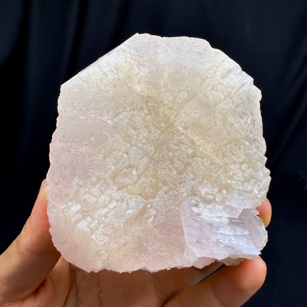 Large peach-pink apophyllite crystal with pearly face from Fujian, China, close-up of the crystal faces