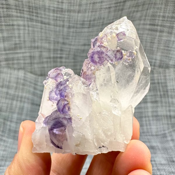 Clear quartz crystal with chain of purple fluorite cubes from Yaogangxian Mine, Hunan, China, second angle
