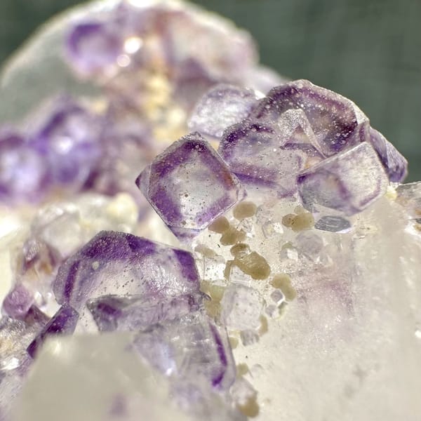 Clear quartz crystal with chain of purple fluorite cubes from Yaogangxian Mine, Hunan, China, reverse side