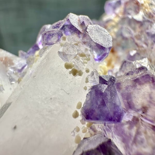 Clear quartz crystal with chain of purple fluorite cubes from Yaogangxian Mine, Hunan, China, top view