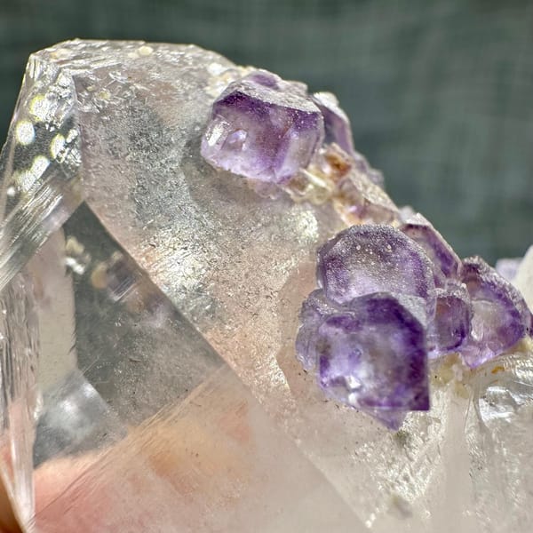 Clear quartz crystal with chain of purple fluorite cubes from Yaogangxian Mine, Hunan, China, another angle