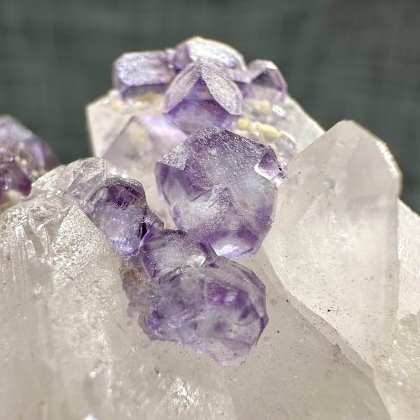 Clear quartz crystal with chain of purple fluorite cubes from Yaogangxian Mine, Hunan, China, base view