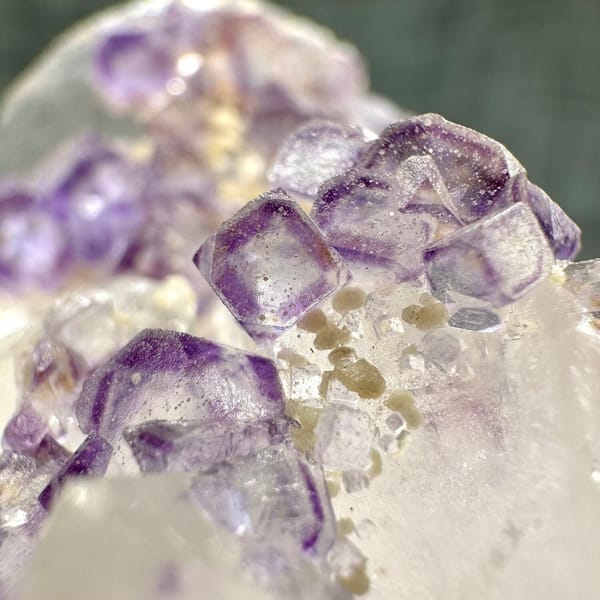 Clear quartz crystal with chain of purple fluorite cubes from Yaogangxian Mine, Hunan, China, detail of the associations