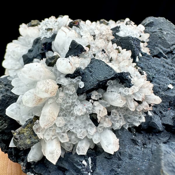 Pale red quartz crystals on black matrix with chalcopyrite from Jiangxi, China, second angle