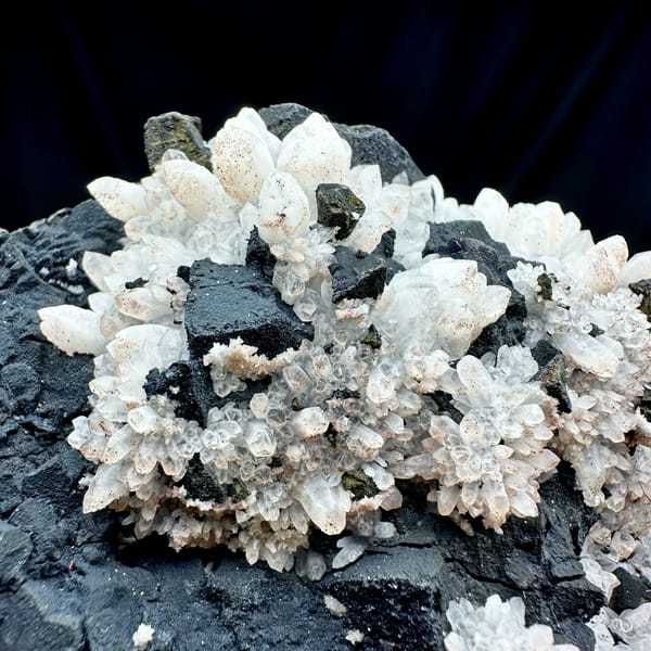 Pale red quartz crystals on black matrix with chalcopyrite from Jiangxi, China, reverse side