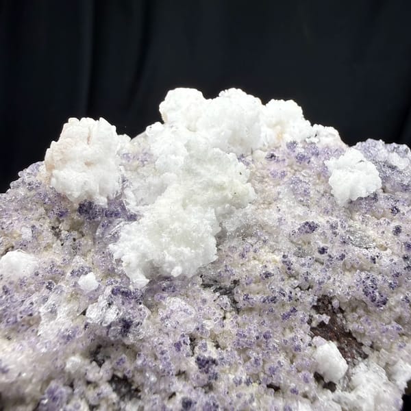 Lavender fluorite plate frosted with white gypsum from Guizhou, China, close-up of the crystal faces