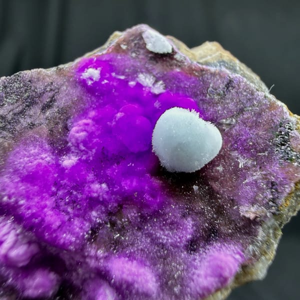 Vivid violet aragonite with blue aragonite ball from Yunnan, China, close-up of the crystal faces