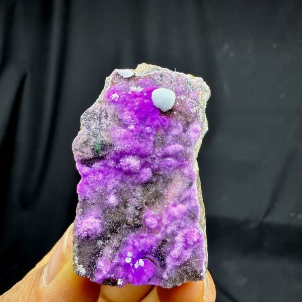 Vivid violet aragonite with blue aragonite ball from Yunnan, China, detail of the matrix contact