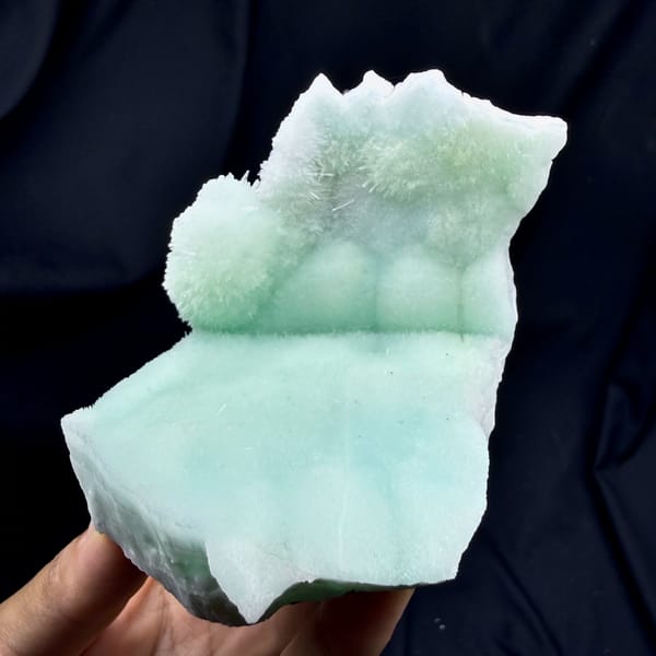 Soft aqua-green acicular aragonite mound from Yunnan, China, close-up of the crystal faces