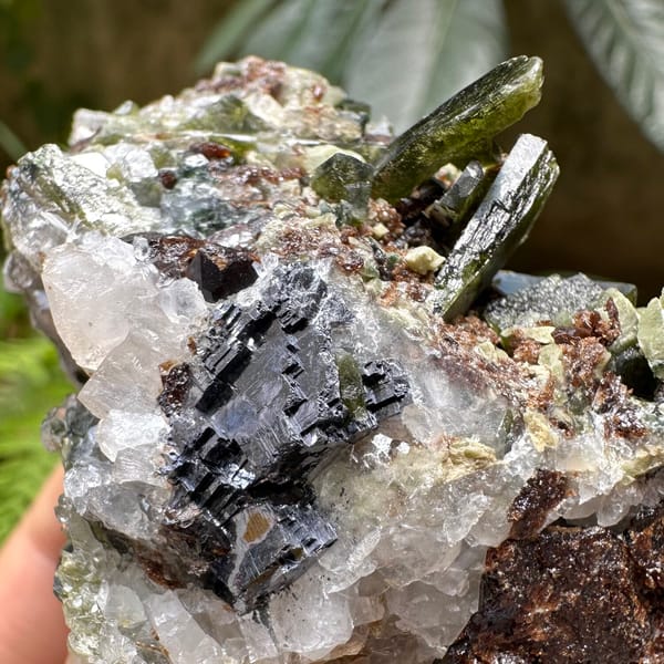 Green diopside crystals with garnet and galena from Inner Mongolia, China, close-up of terminations